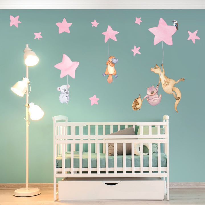 Nursery with decals of Australian animals hanging from stars on the wall